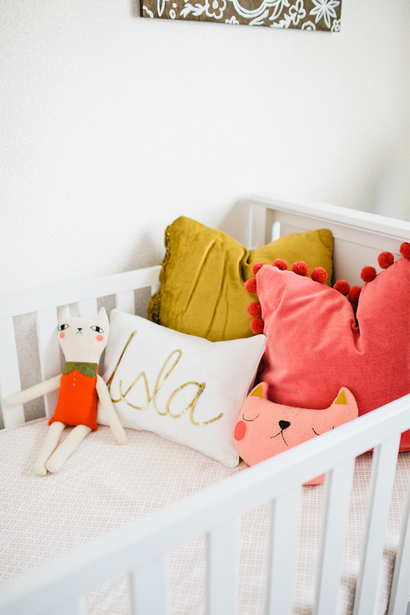 orange pink pillows nursery