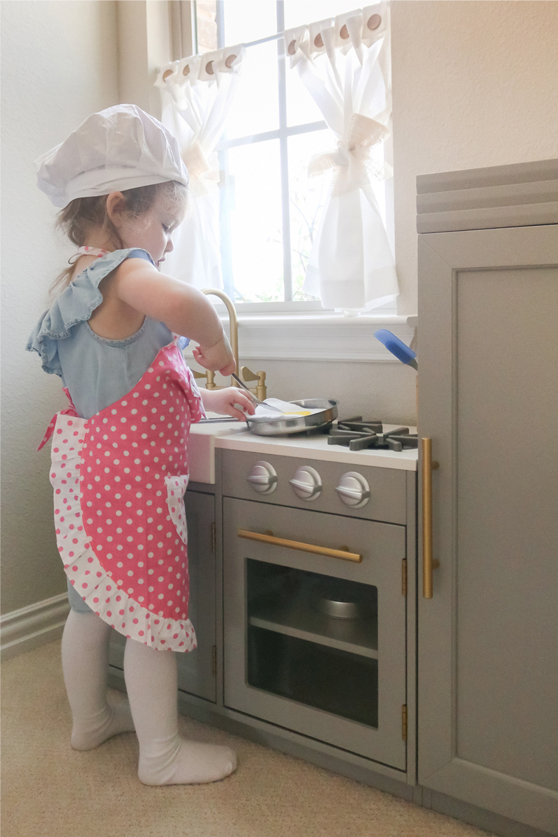 girl playing in playkitchen